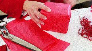 video of someone wrapping a gift